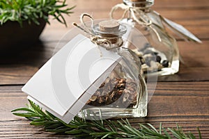 Bottle of healthy herbs with white empty label for you text. Glass bottle of dry medicinal herbs for making healing infusion or