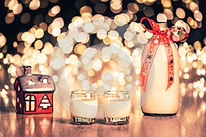 bottle of homemade eggnog on dark background with starry background