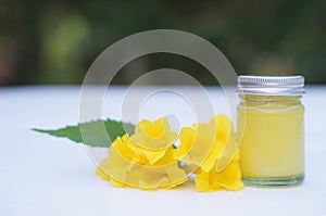 Bottle of homemade Thai herbal ointment, balm.Decorated with yellow flower.