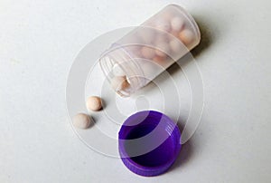 Bottle of homeopatic tablets on white background