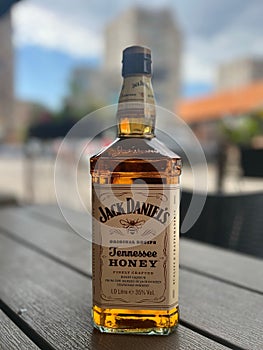 Bottle of Jack Daniels Tennessee Whisky placed on top of a rustic wooden table