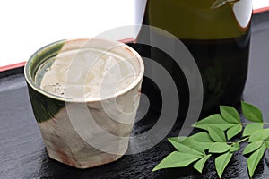 Bottle of Japanese shochu and ceramic bowl