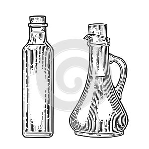 Bottle and Jug glass of liquid with cork stopper. Olive oil.