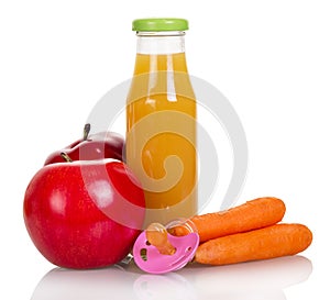 Bottle of juice, apples, carrots and dummy isolated on white.