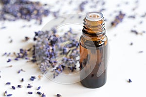 A bottle of lavender essential oil on a white background