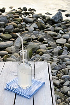 Bottle with lemonade at the beach