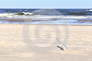 Bottle with letter on a beach, shallow depth of field