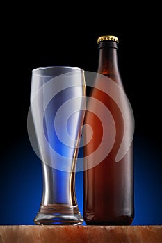 Bottle of light beer and an empty glass