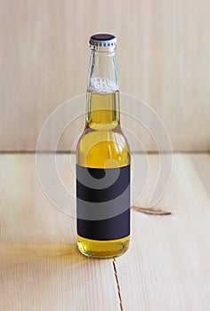 Bottle of the light beer on the wood background with dark mockup