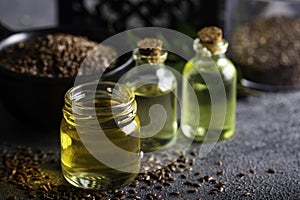 Bottle of linseed oil and linseeds in bowl.