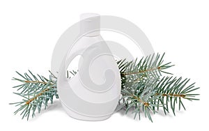 Bottle of liquid soap and fir branches on white