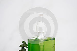 Bottle of liquid soap. The bottle is green and clear, and the soap is in a pump dispenser