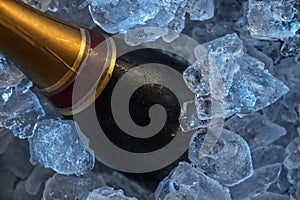 Bottle of luxury champagne in frape with ice. photo