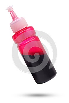 Bottle of magenta ink for inkjet printer isolated on white background