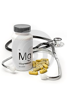 Bottle of Magnesium vitamins with stethoscope photo
