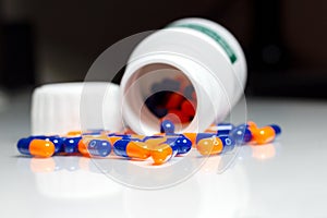 Bottle of medical pills or capsules isolated over white