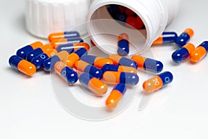 Bottle of medical pills or capsules isolated over white