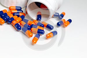 Bottle of medical pills or capsules isolated over white