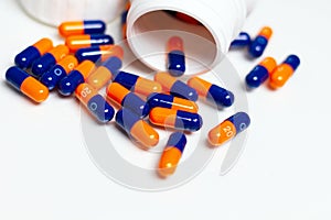 Bottle of medical pills or capsules isolated over white