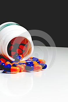 Bottle of medical pills or capsules isolated over white