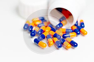 Bottle of medical pills or capsules isolated over white