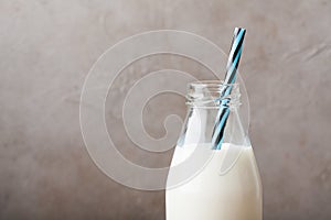 Bottle with milk on dark background with copy space