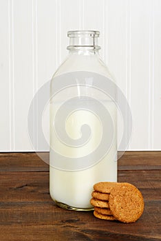 Bottle of milk with ginger snap cookies