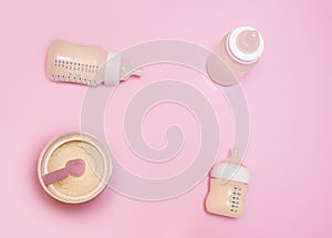 Bottle of milk for a newborn on a pink background