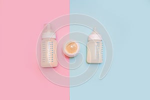 Bottle of milk for a newborn on a pink background