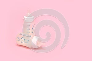 Bottle of milk for a newborn on a pink background