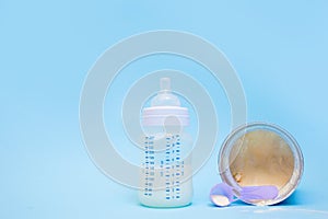 Bottle of milk for a newborn on a pink background