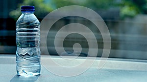 a bottle of mineral water on the dashboard of the car. Bottled water was left in the car for a long time
