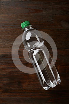 Bottle of mineral water on a wooden background