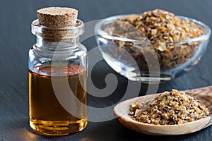 A bottle of myrrh essential oil with myrrh resin