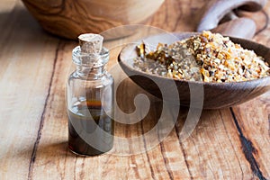 A bottle of myrrh essential oil with myrrh resin