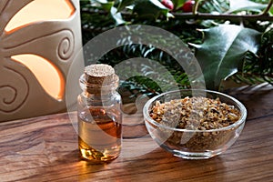 A bottle of myrrh essential oil with myrrh resin in a glass bottle