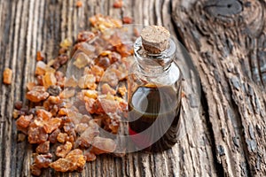 A bottle of myrrh essential oil with myrrh resin crystals
