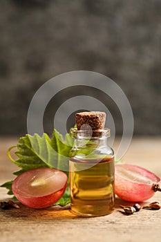 Bottle of natural grape seed oil on table. Organic cosmetic