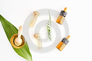 Bottle of natural oil placed, Blank label package for mockup on white background and flowers.