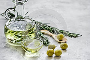 Bottle with olive oil and herbs on stone background mockup