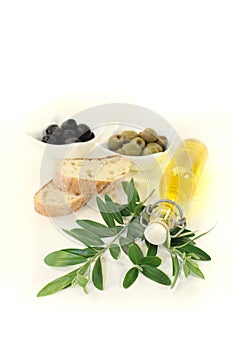 Bottle of olive oil with olives and branch