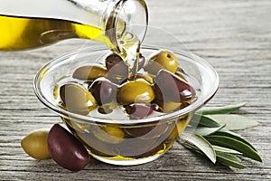 Bottle of Olive oil pouring in glass