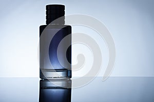 Bottle of perfume on black acrylic sheet