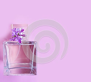 Bottle perfume flower lilac on a colored background