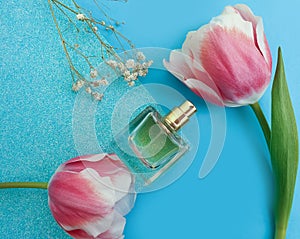 Bottle perfume flower tulip on colored background