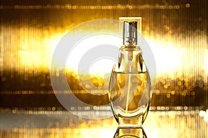 Bottle of perfume on gold background