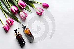 Bottle of perfume and pink tulip flowers on pastel color background. Copyspaces