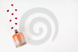Bottle of perfume with red hearts flying out from it.