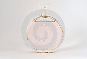 Bottle of perfume on a white background with light shade, grace