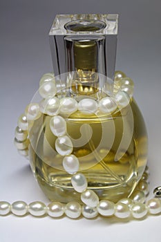 Bottle of perfumes and pearl